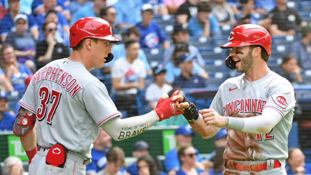 May 21, 2022; Toronto, Ontario, CAN; Cincinnati Reds right field Tyler Naquin (12) celebrates a run with catcher Tyler Stephenson (37) in the fourth inning against the Toronto Blue Jays at Rogers Centre. Mandatory Credit: Gerry Angus-USA TODAY Sports